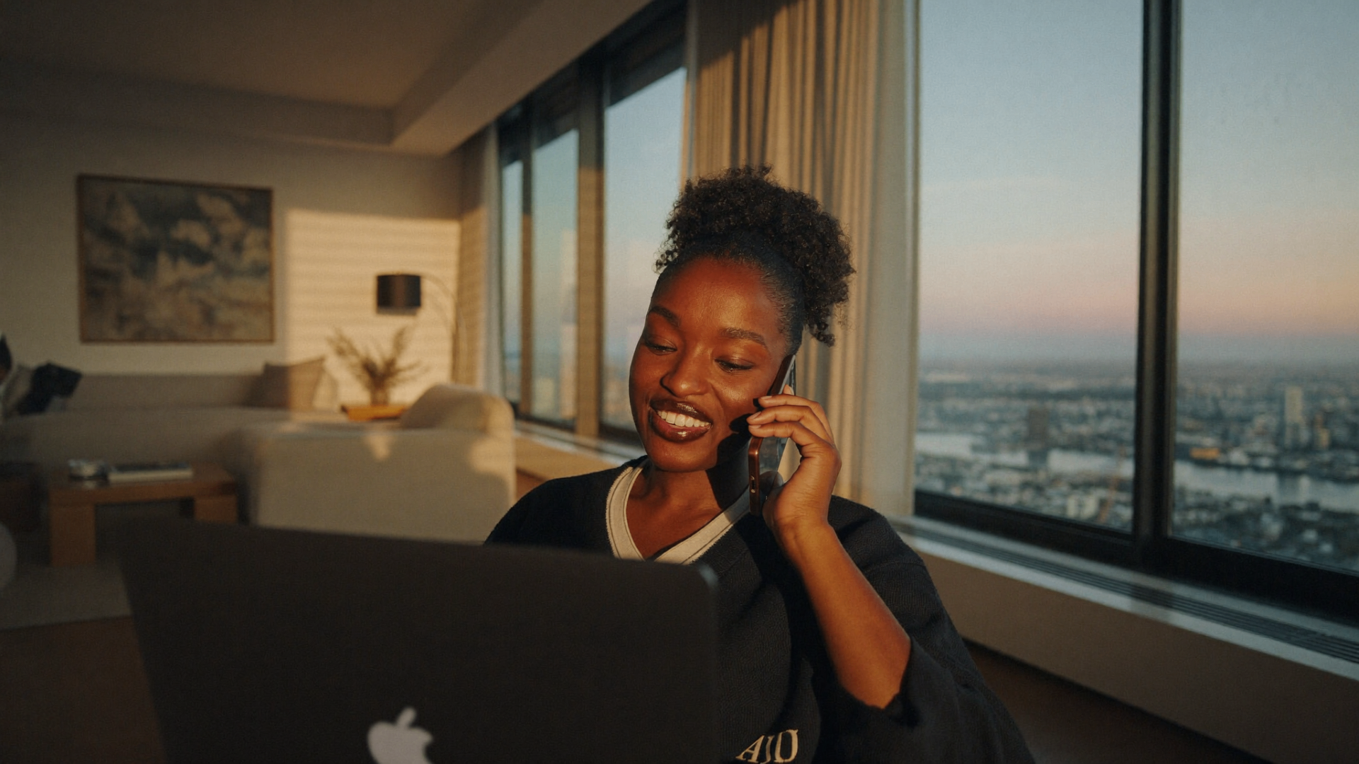 Representative working from a high-rise apartment at sunset
